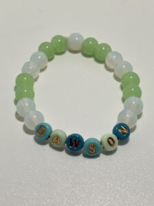 This bracelet has the name Dawson, but you can Order it in the size, color and Name or words you would like. Measure wrist for accurate size. If ordering by age then approximate bone structure. like small med. or large wrist for: age group. 