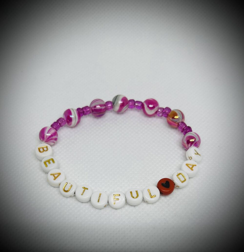 Multi pinks and white beads with word's that say: Beautiful Day