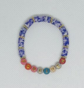 Purplish blue marble clay beads, word pictured is: Forgiven