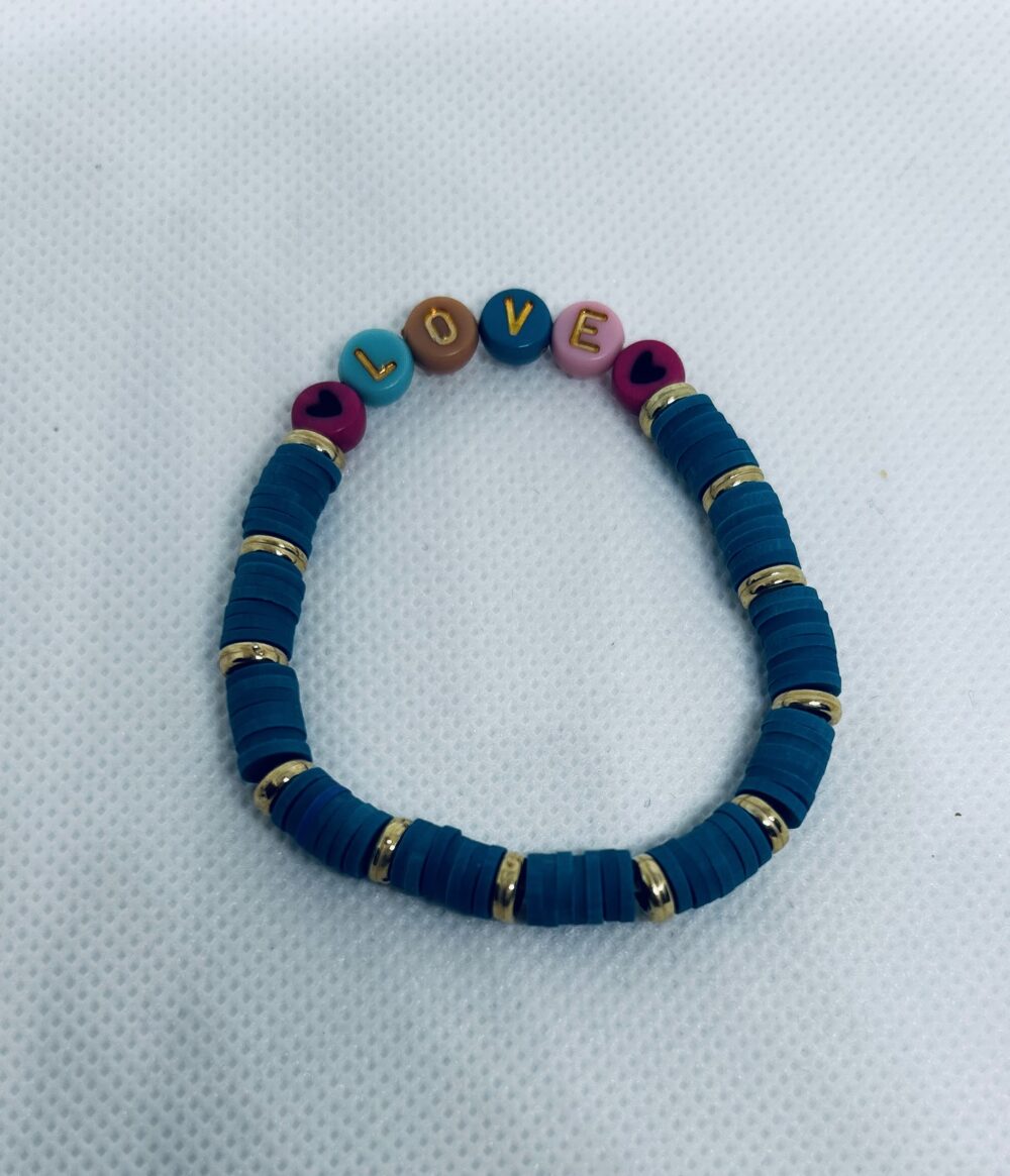 Mediterranean color clay beads with gold spaces. LOVE with a heart on each size.